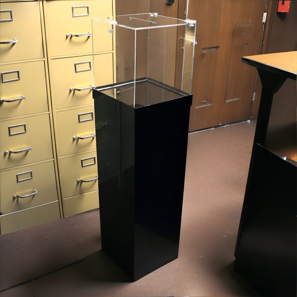 clear donation box on black pedestal